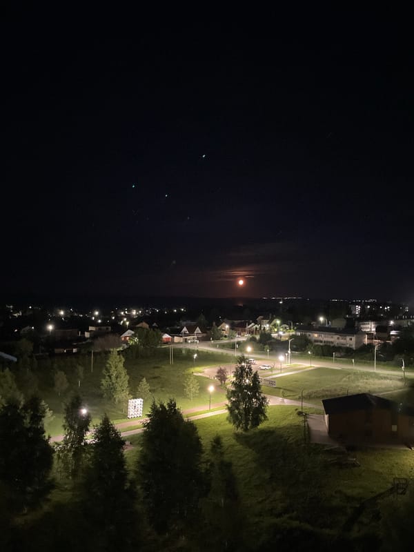 Full orange moon rises over Laishevo on a June night