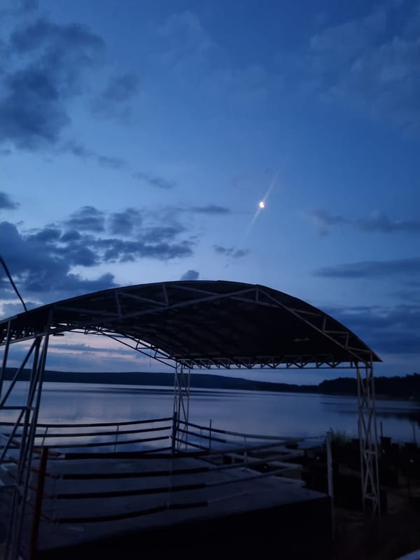 Outdoor boxing ring by the Kama River at twilight