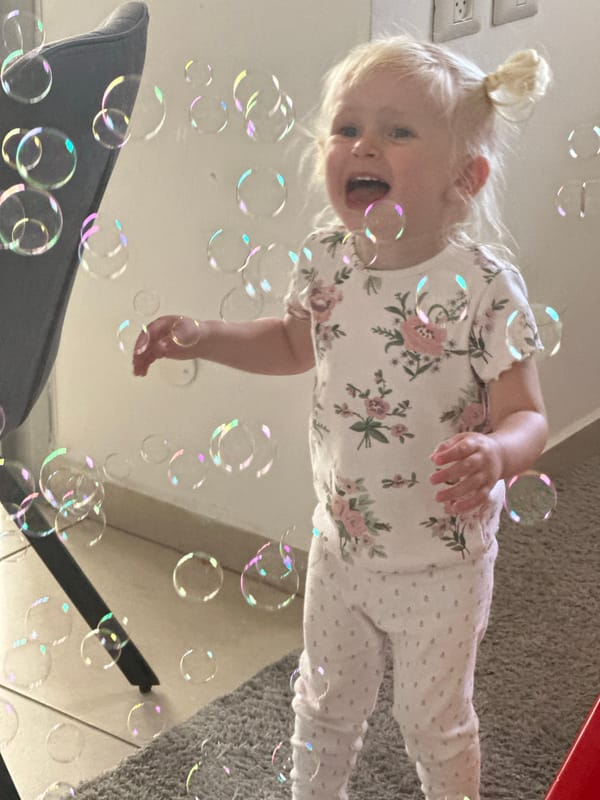 Toddler plays with soap bubbles in Petah Tikva home