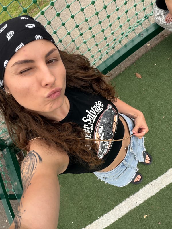 Young woman takes selfies on artificial turf in Kiryat Bialik