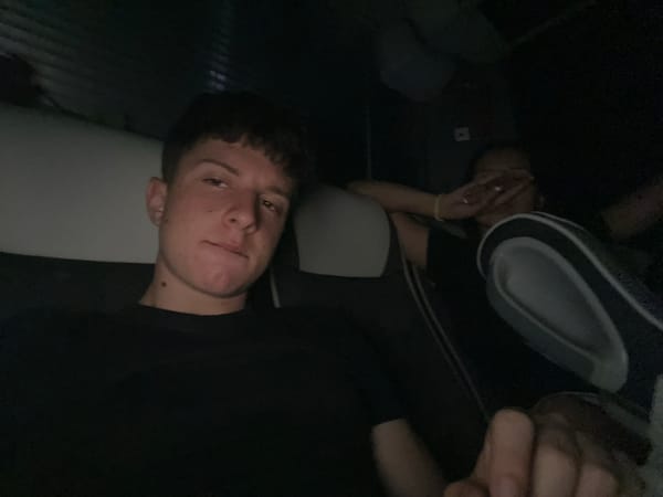 Friends pose playfully in vehicle seats in Bulgarian town