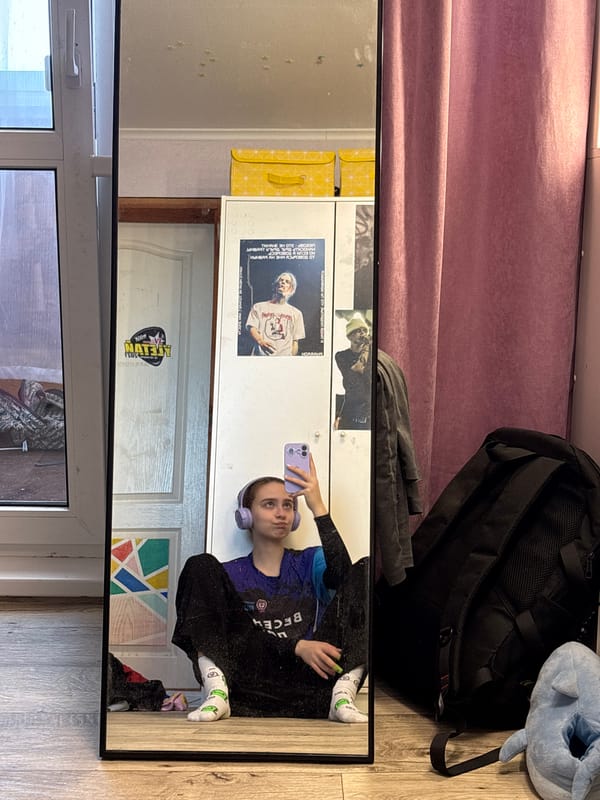 Person takes purple phone selfie in Russian room mirror