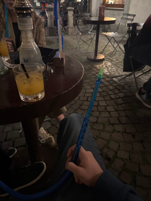 Evening social gathering captured at Turin outdoor cafe