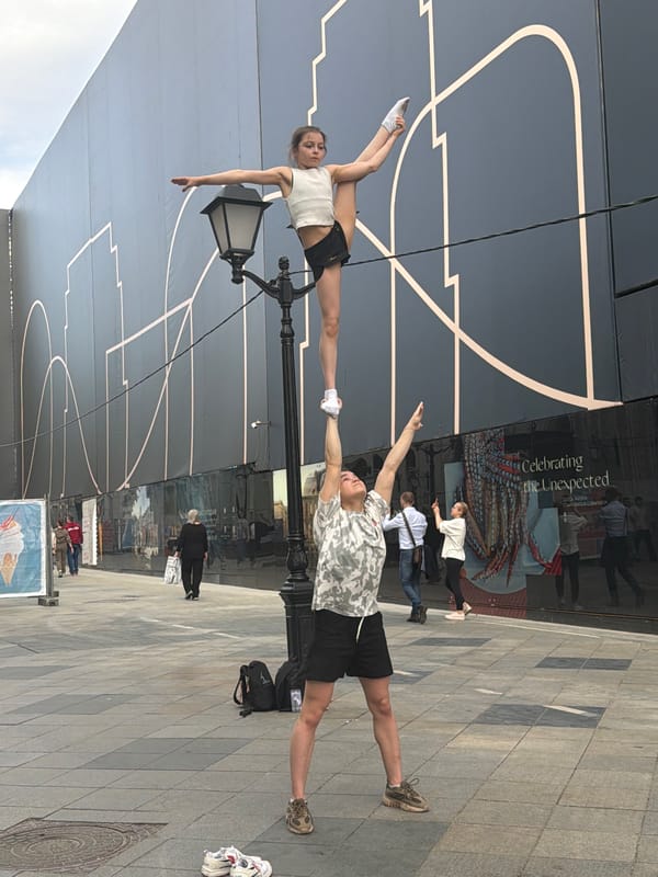 Street acrobats perform balancing stunt on Moscow lamppost