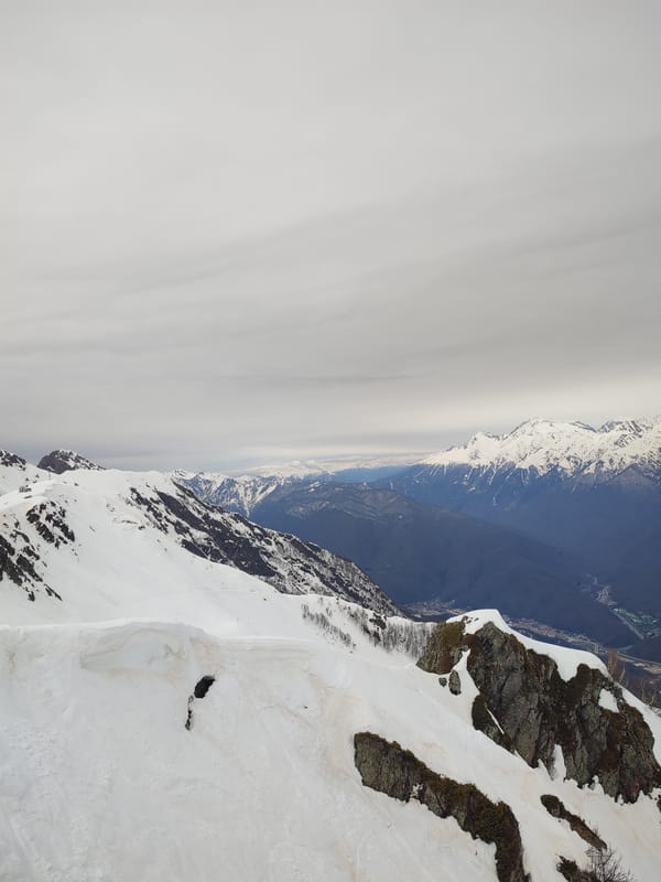 Visitors document snowy mountain scenes at Estosadok alpine landmark
