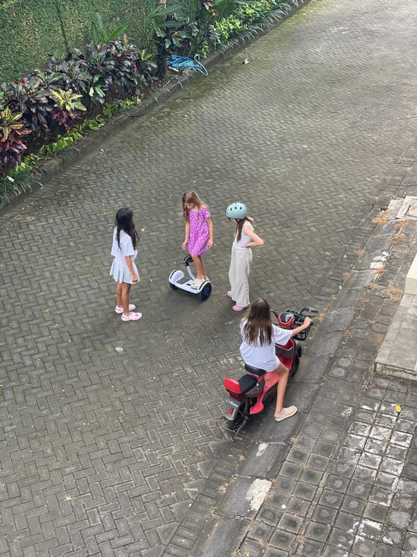 Early morning scenes of children playing, street traffic in Kuta Selatan
