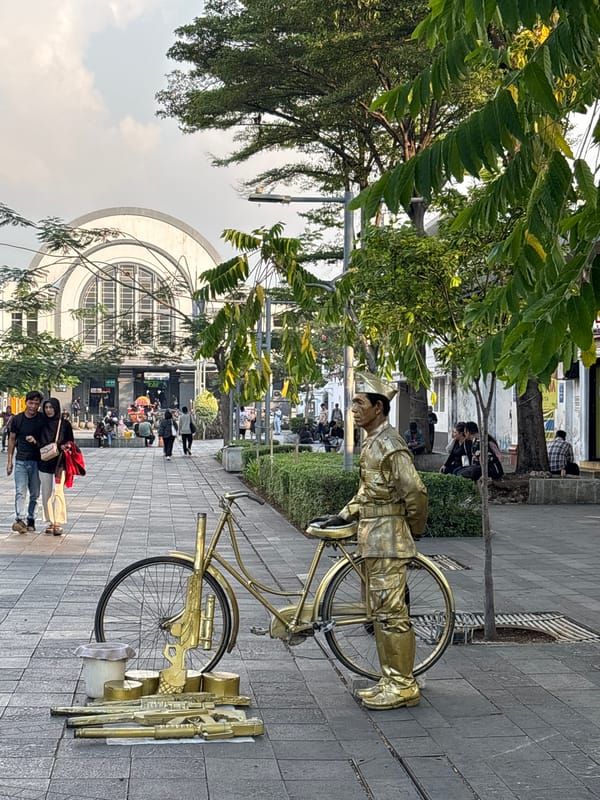 Street performers and tourists in Jakarta's historic Kota Tua district