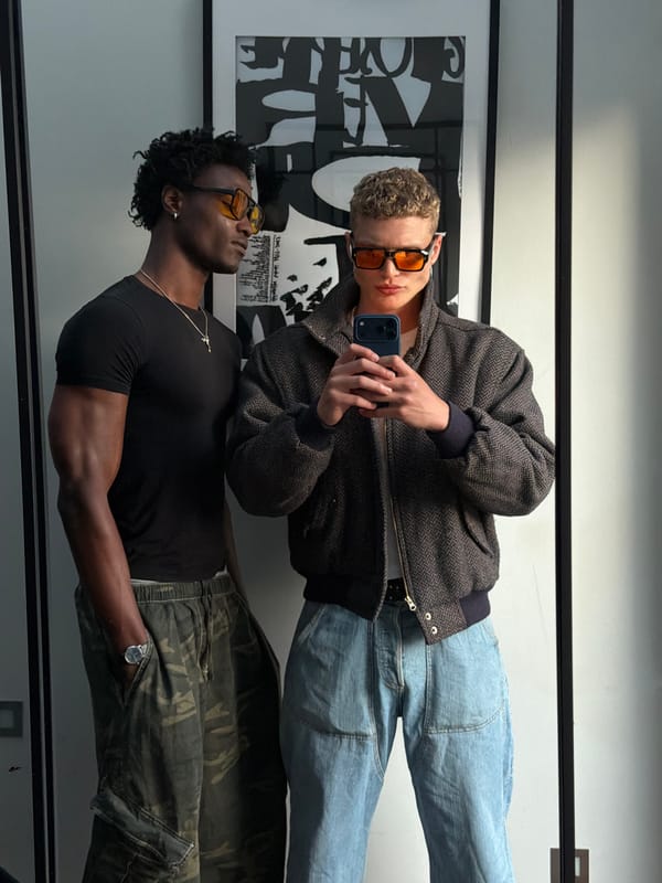 Two men take mirror selfies in London indoor location
