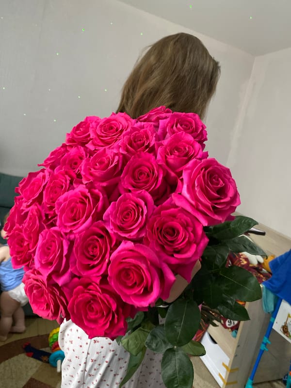 Woman receives pink roses during home cooking in Votkinsk