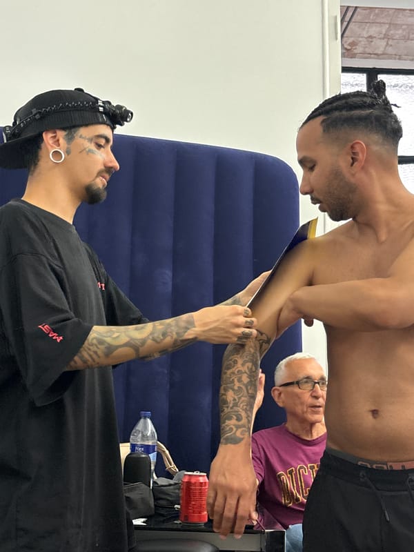 Tattoo session documented in Barcelona with artists and clients