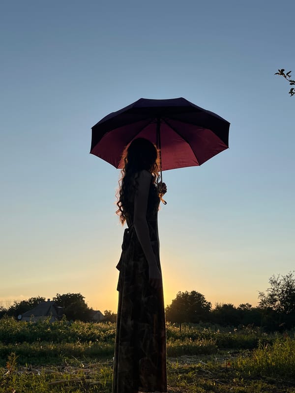 Sunset silhouette series with a maroon umbrella at golden hour