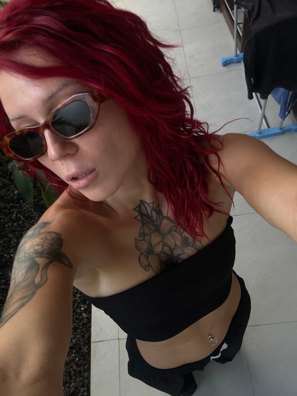Red-haired person poses for outdoor selfies in North Kuta