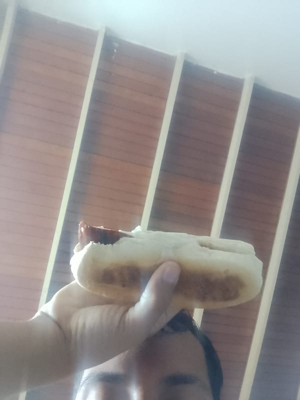 Person enjoys hot dog lunch in El Espinal, Venezuela
