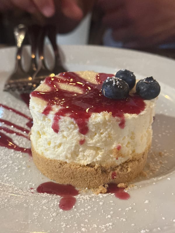 Evening restaurant scene with plated dessert in Oeiras