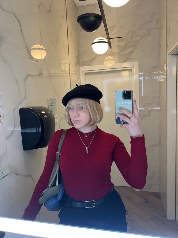 Young person takes mirror selfies in Odesa restroom
