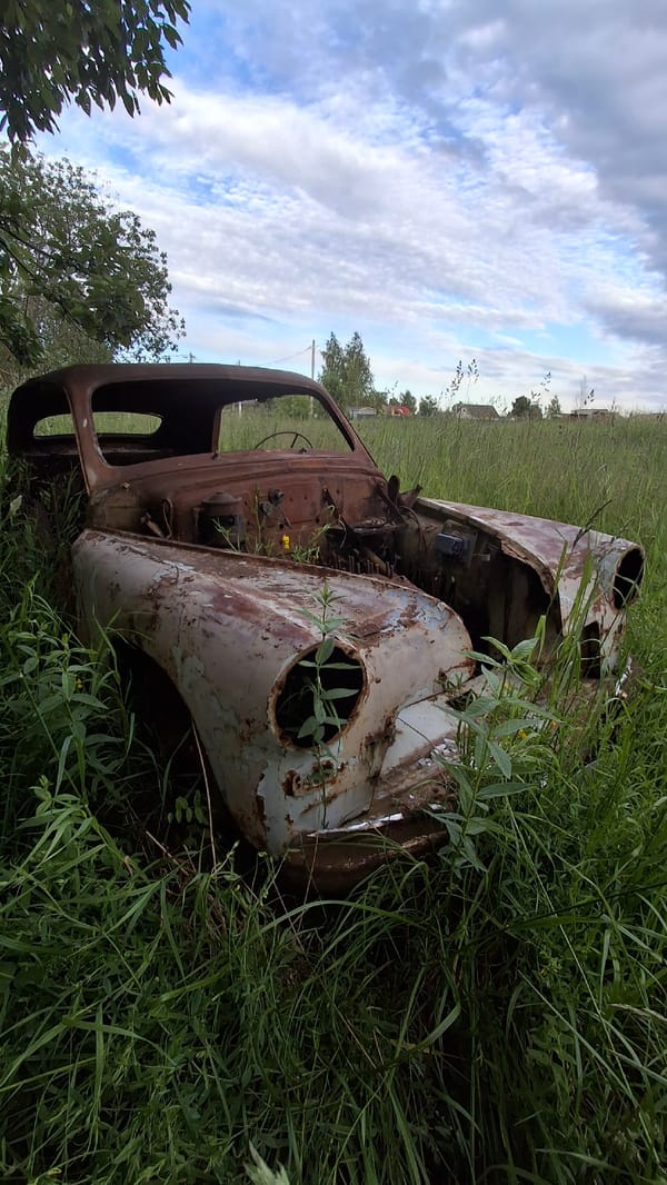 Kid explores field of abandoned construction vehicles in rural Russia