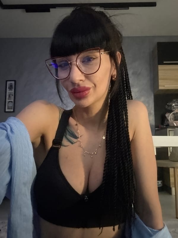 Indoor portrait with cat-eye glasses in Varna, Bulgaria.