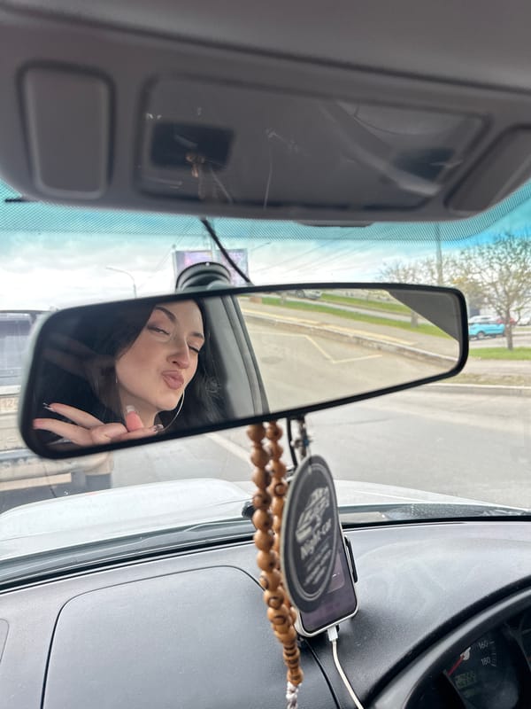 Two women singing in car during Krasnoyarsk traffic stop