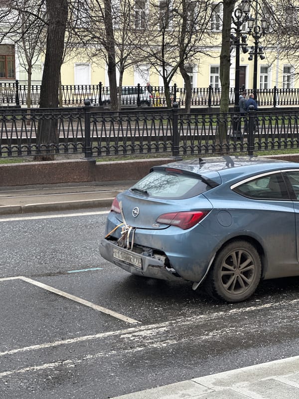 Damaged Opel Astra observed on Moscow street amid wet conditions