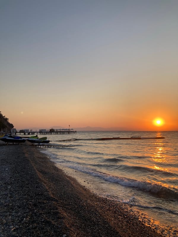 Kemer beach at sunset, prayer flag in the foreground