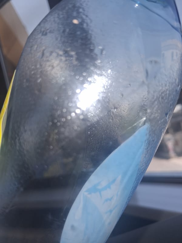 Multiple angles on an ASU water bottle, with eclectic indoor details