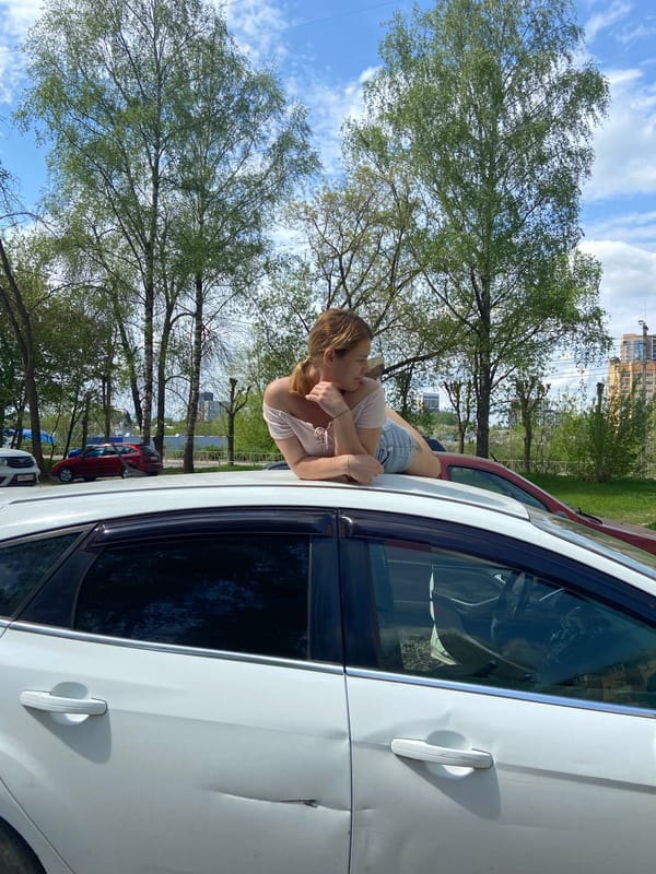 Woman enjoys sunny morning walk with dog in Ryazan