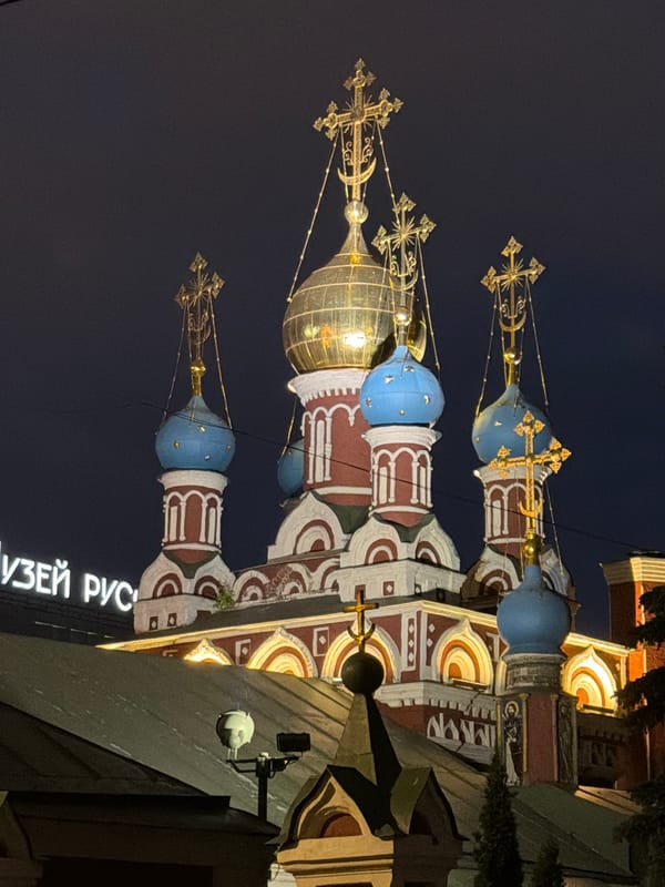 Moscow's historic churches illuminate evening cityscape amid regular traffic