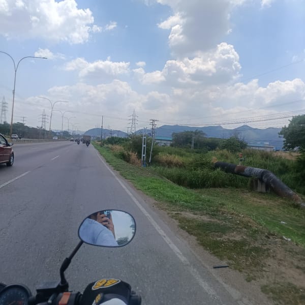 Motorcycle rider travels highway in Los Guayos, Venezuela