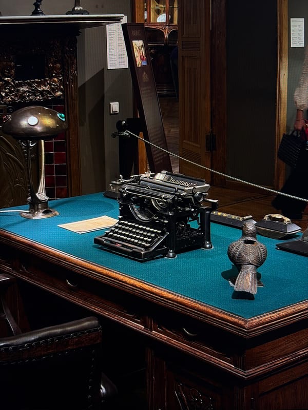Inside a historic house museum with period rooms and art nouveau details