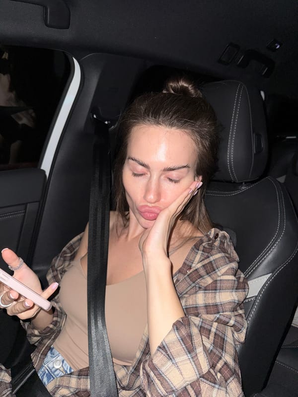 Woman rests in car passenger seat during nighttime