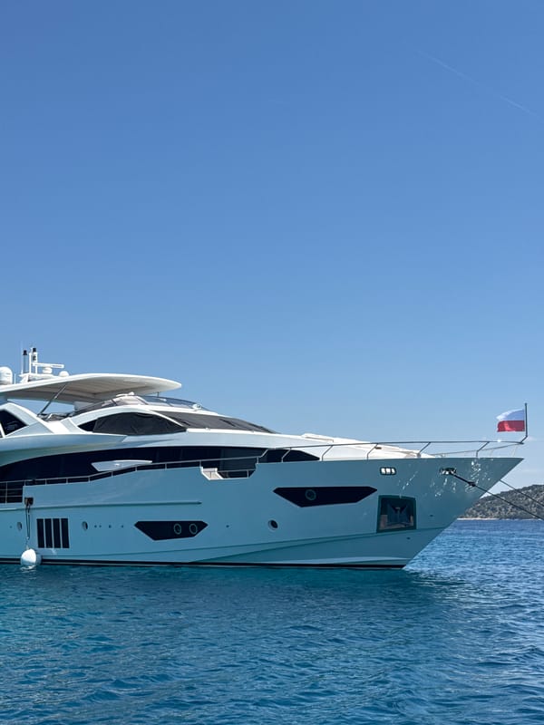 Luxury yacht anchored off Šibenik with waterside dining nearby