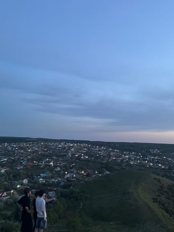 Town captured at dusk from elevated and waterside perspectives