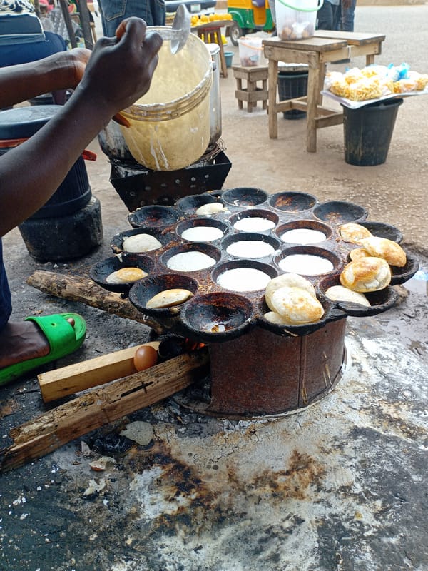 Street vendors prepare traditional puff-puff snacks in Bukuru Nigeria
