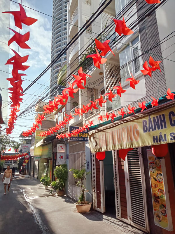 Red paper decorations illuminate narrow Nha Trang street