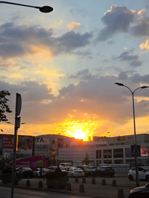Dramatic sunset illuminates Warsaw commercial district glass facades