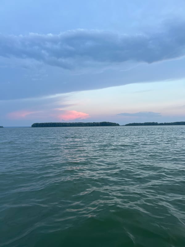 Still water and pastel skies near Novopichugovo at golden hour