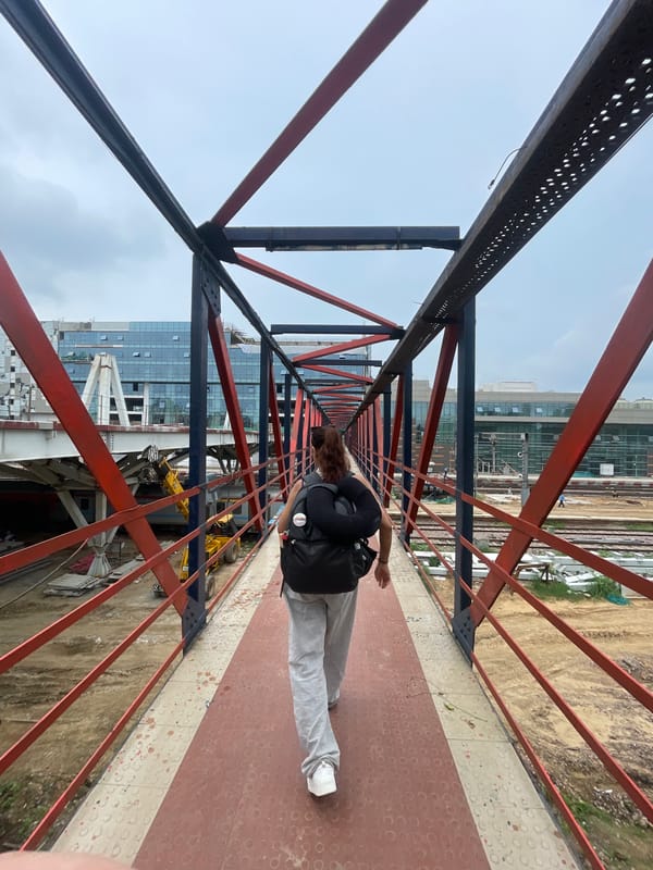 Construction and commuter activity around a New Delhi rail corridor