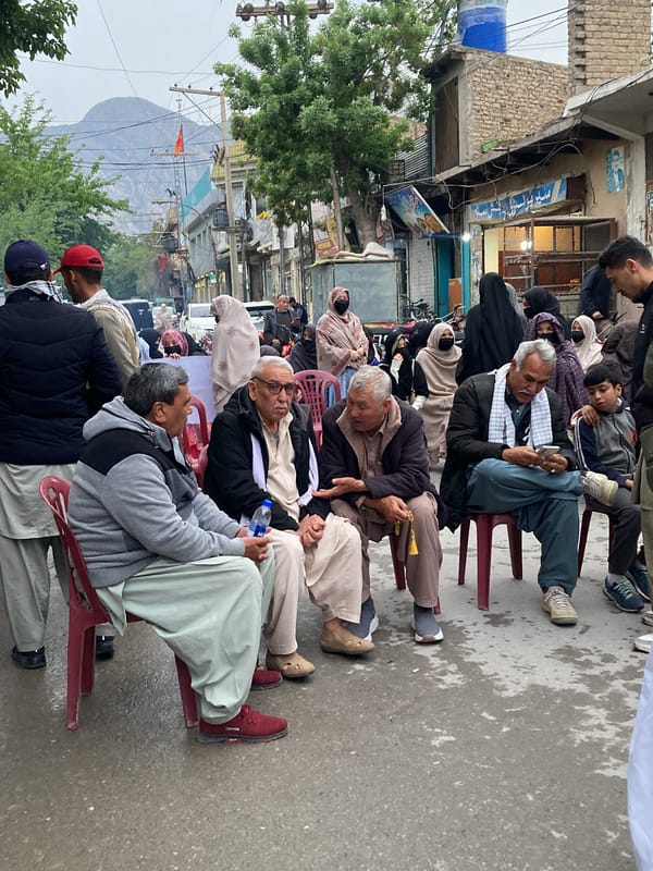 Men gather for conversation on Quetta street