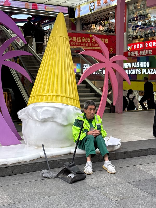 Scooter rider in yellow gear spotted on Jinjiang sidewalk