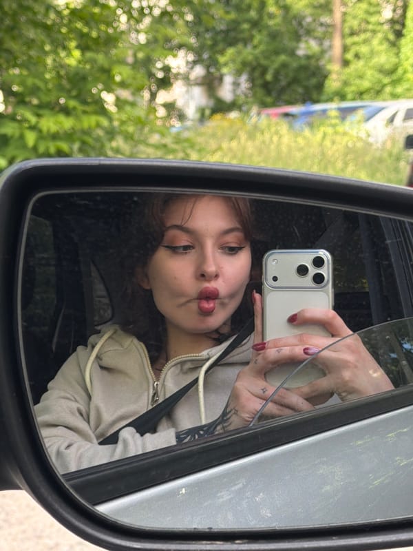 Woman takes selfies in car during afternoon photo session
