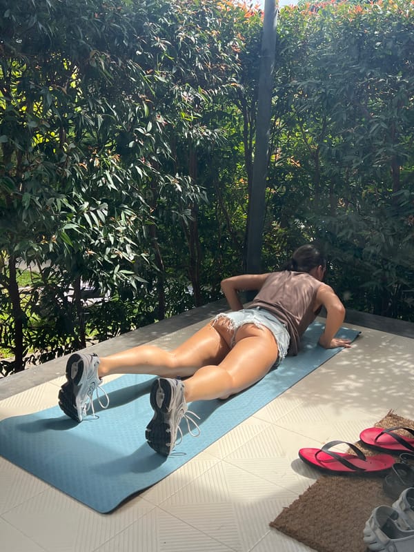Woman completes morning yoga session on Thai patio with dog