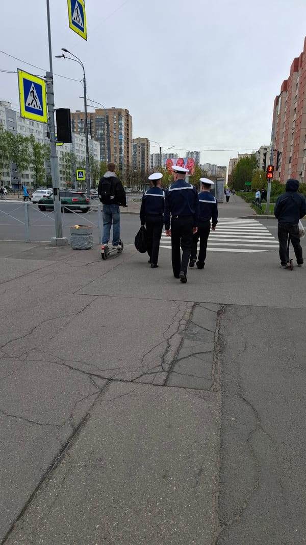 Sailors cross street near church in Saint Petersburg