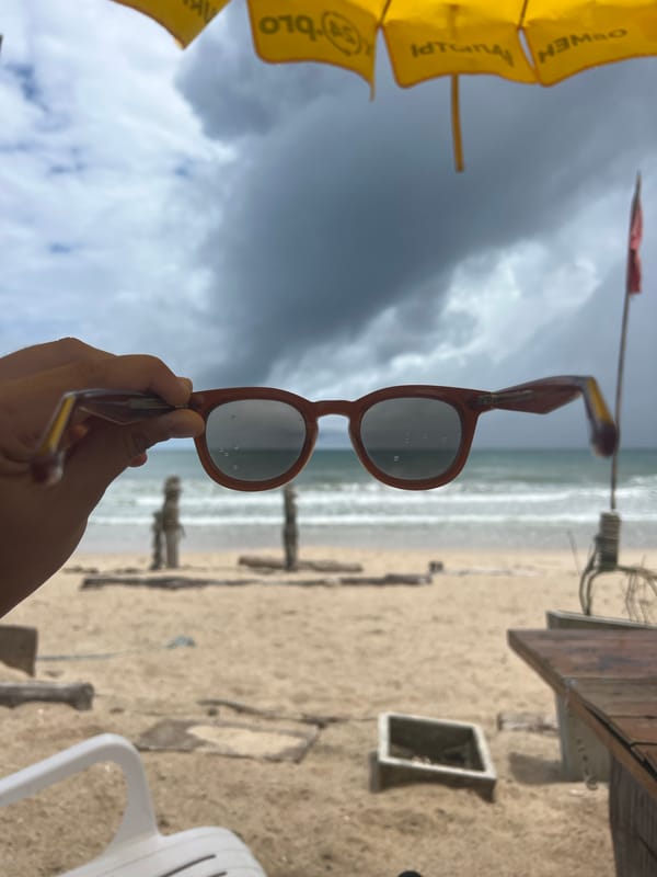 Stormy beach day with vendors, swimmers, and laptop workers