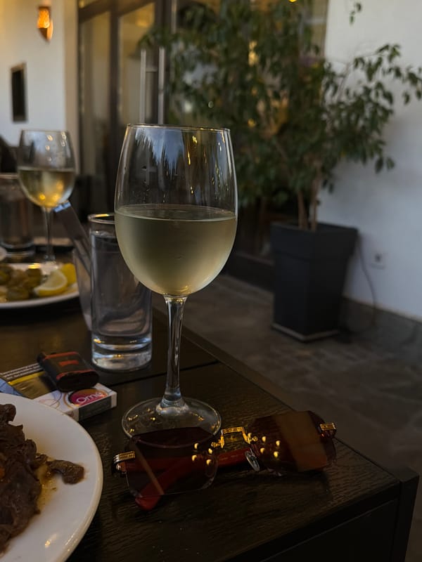 Outdoor café evening in Krasnovo, wine and a cat included