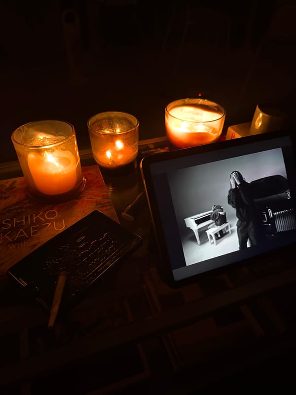 Three candles illuminate dimly lit scene in Milan