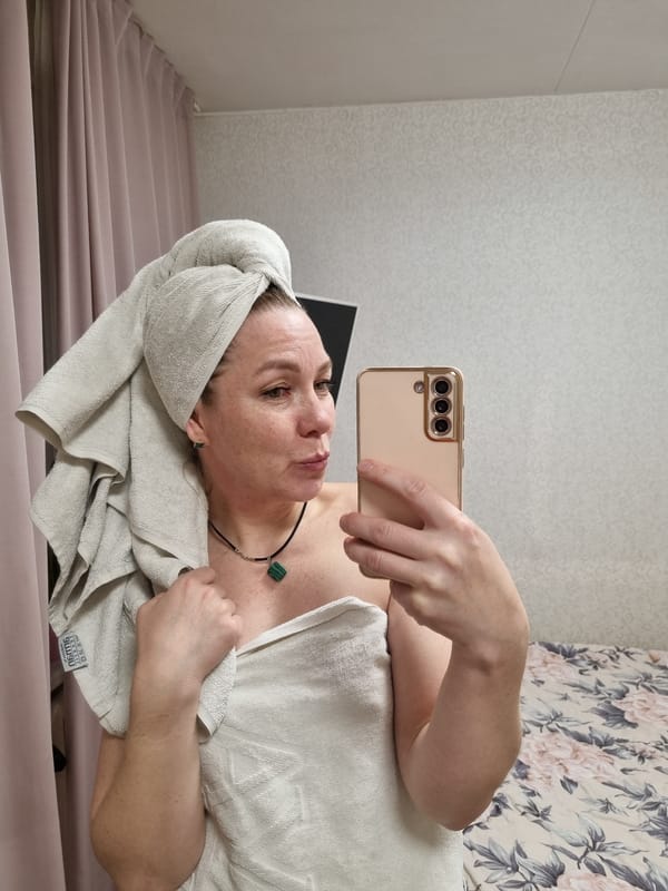 Woman takes post-bath selfies in bedroom in Chaikovsky
