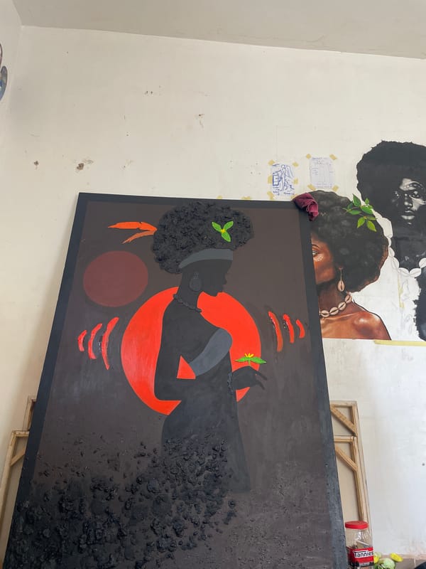 Artist creates portrait paintings in Ado studio workspace