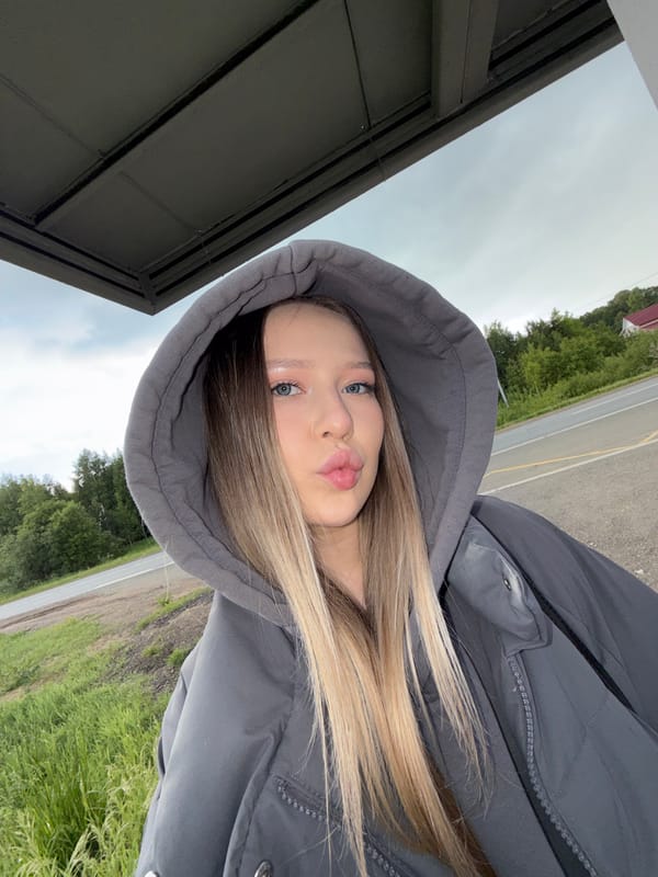 Young woman takes selfies on rural Russian roadside