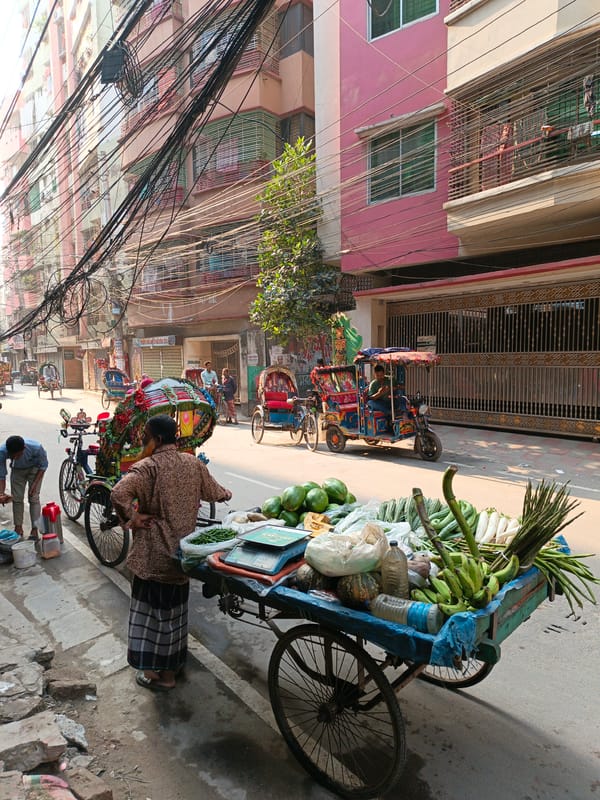 Street vendors sell produce from carts in Dhaka