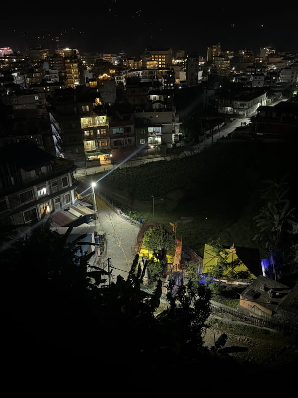Nighttime aerial view captures illuminated Pokhara cityscape